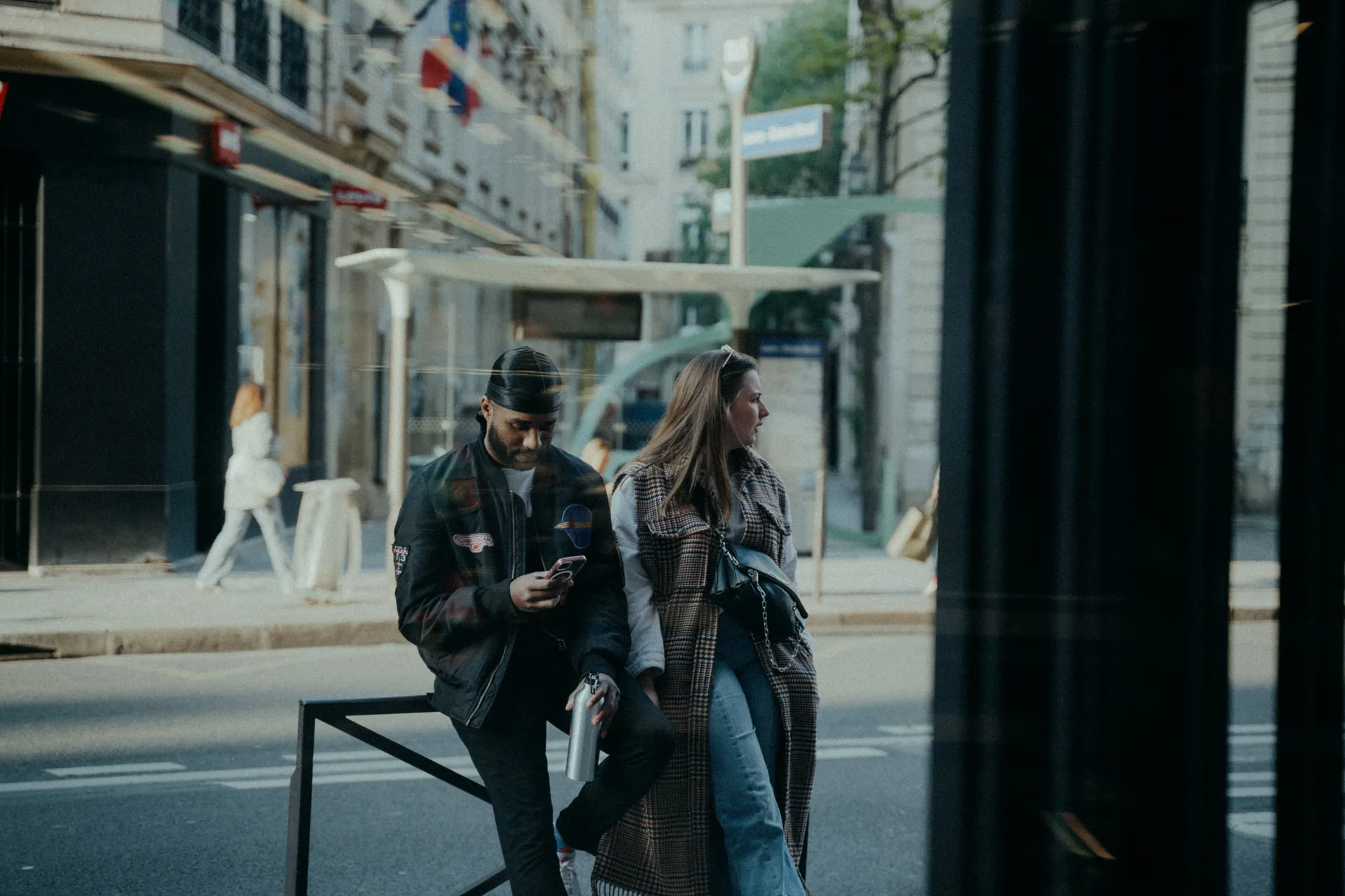 Un homme et une femme sont assis contre une barrière en attendant une soirée d'entreprise couverte par Jeremy Dan, photographe d'entreprise.